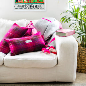 White Couch with Red Checked Harris Tweed Cushion from the Outer Hebrides and Pink Ikat Cushion from Bali, Indonesia
