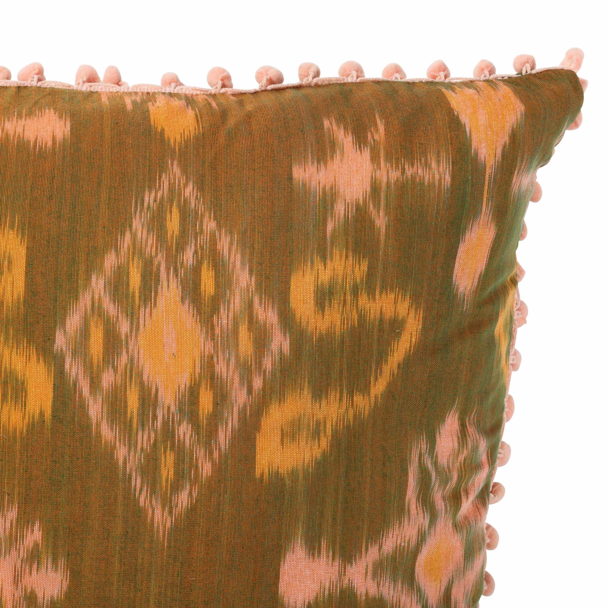 Peach and Olive Green Cotton Ikat Square Scatter Cushion with Pink PomPom Trim from Bali, Indonesia - DETAIL