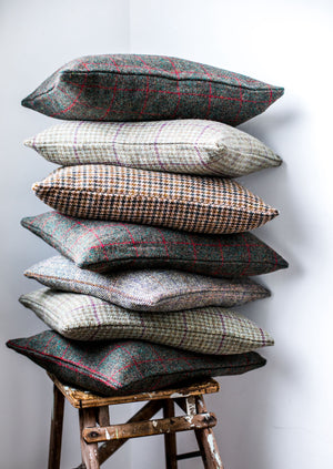 Harris Tweed Cushions Stacked in a Wooden Stool